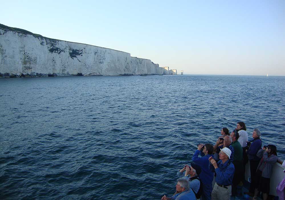 People aboard in front of Old Harry Rocks - City Cruises Poole